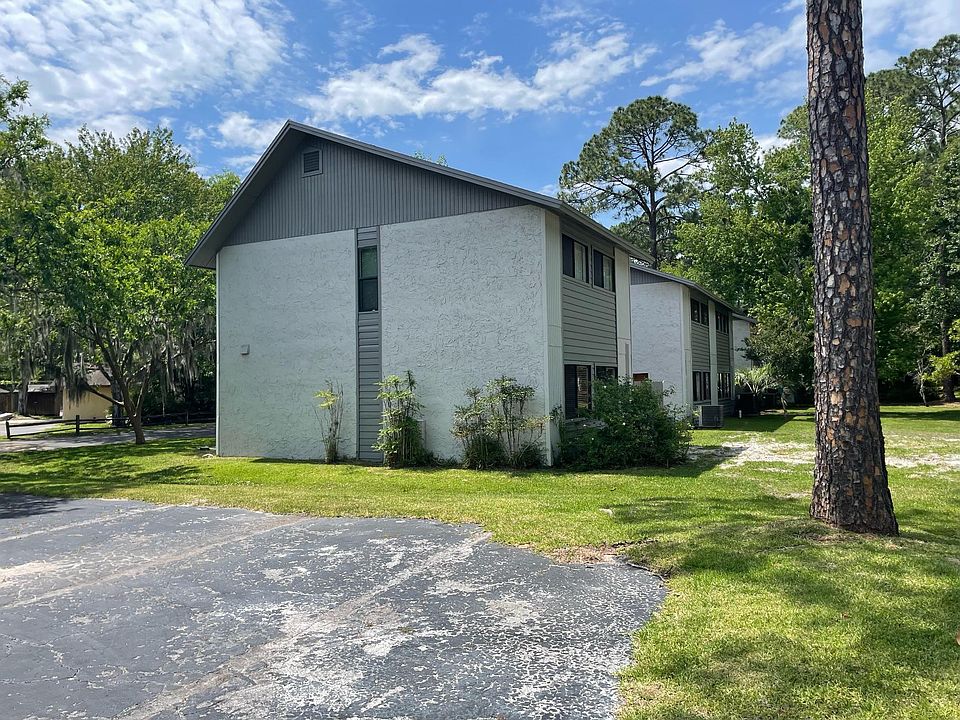 Side photo of home showing attached it is an end unit, and has ample extra parking