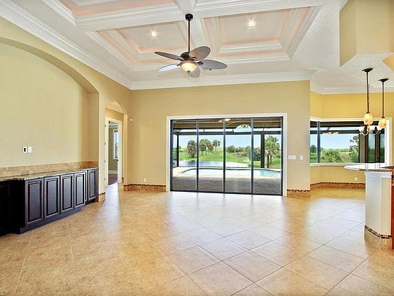 Great room with large entertainment wall & views overlooking lake and golf tees...