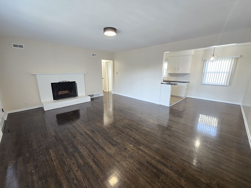 Large living room with Fireplace, Hardwood Flooring that opens into the dining room...