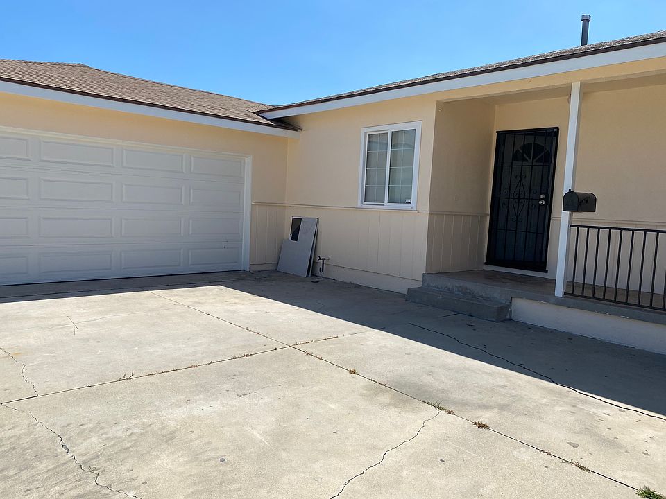 front door with patio and garage