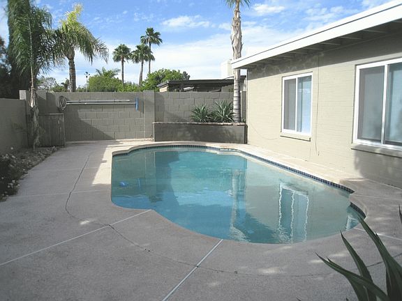 Refreshing Pebble-Tec Pool with Fence
