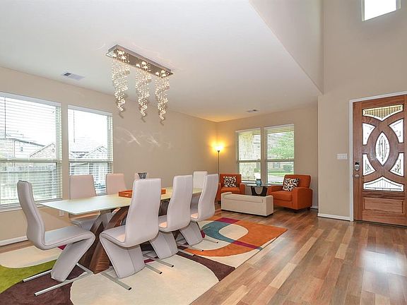 The formal living and dining area are combined. Home has upgraded light fixtures, blinds and laminate hard wood floors.