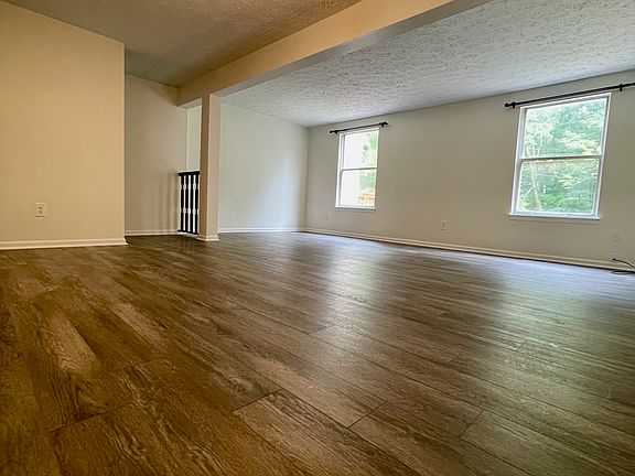 Living and dining room with new wooden flooring.