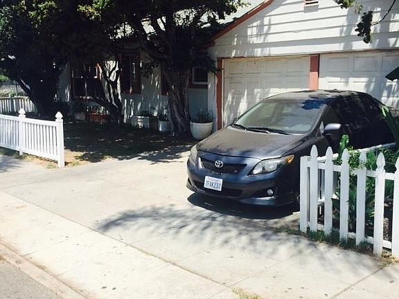 garage separates the two properties. Flower Street to the left, 15th to the right