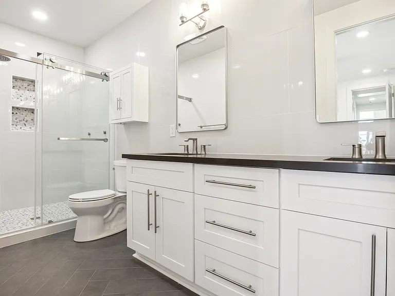 Master bathroom with his and hers sinks and an extra large 6-jetted luxury shower.
