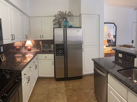 Ample kitchen counter space and storage and full-size refrigerator.