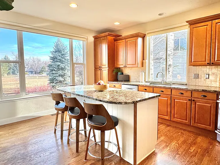 Sunny, fully-equipped kitchen with huge windows on three sides