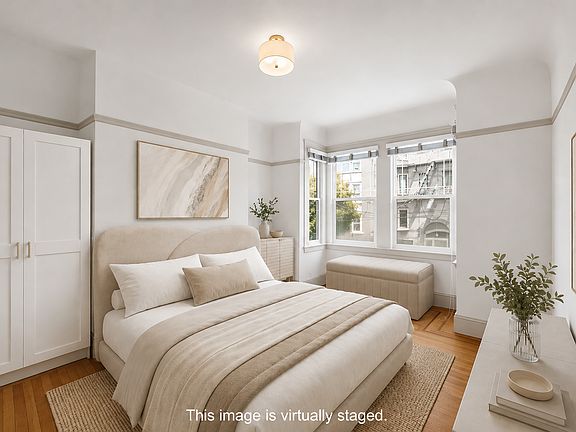 Light & bright 1st bedroom with view to the front of the unit. Armoire included in unit.