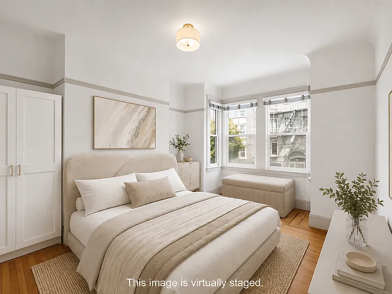 Light & bright 1st bedroom with view to the front of the unit. Armoire included in unit.