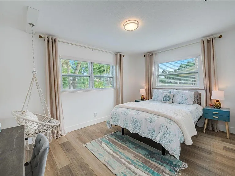Bedroom 2. Cozy Queen with lux sheets, comforter, pillows and adjustable bed remote. Office Desk and fun swing chair.