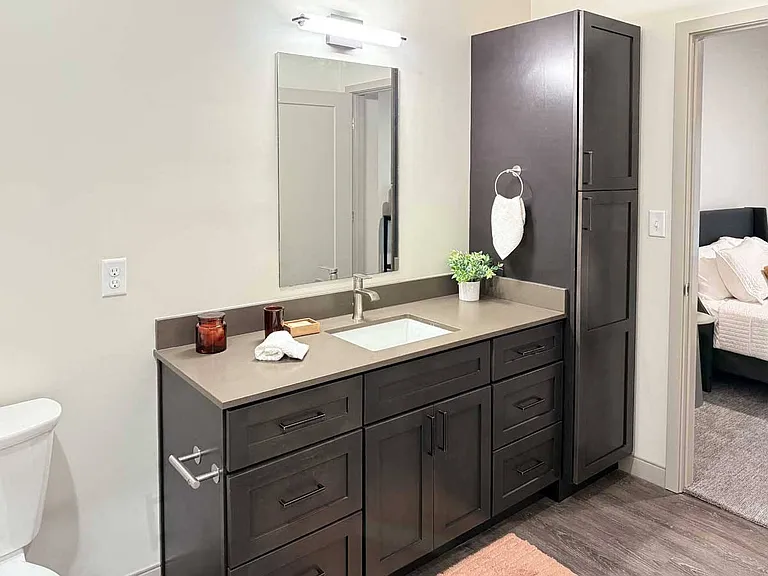 Start your day in this stylish bathroom, featuring a spacious vanity and plenty of storage for all your essentials.