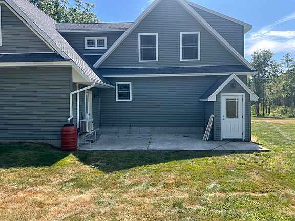 Back of house with concrete patio