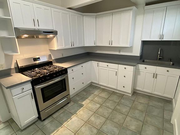Kitchen With New Quartz and Gas Stove