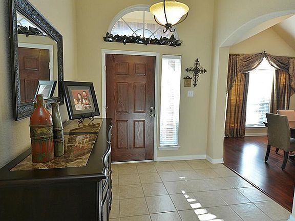 Entry to the home features a wide foyer and high ceilings.