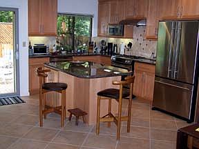 Open kitchen/dining area for easy entertaining. Modern, upgraded appliances. Dishwasher, Microwave, gas range/oven, refrigerator/freezer. Ceramic tile floor, granite counter tops, spacious island with seating.