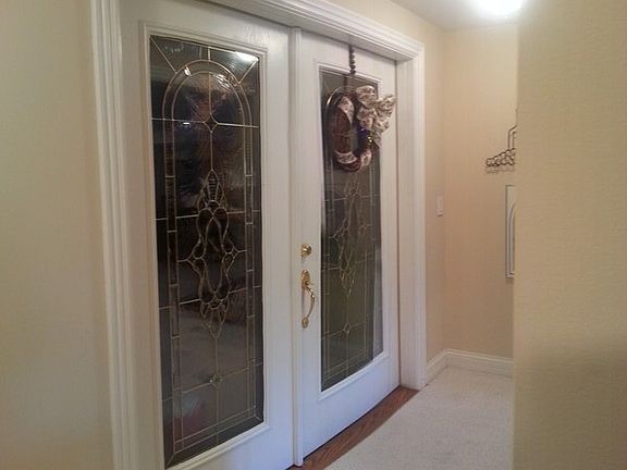 Elegant glass doors welcome you to your private Wine Tasting Cellar