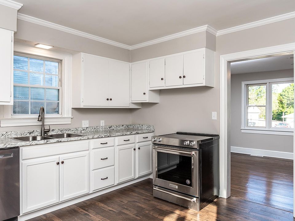 Kitchen is roomy with tons of counter space, cabinets, and all new stainless steel appliances.