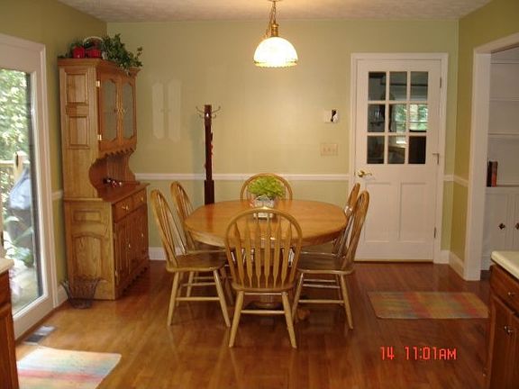 Dining area with view to great room and entry onto deck.