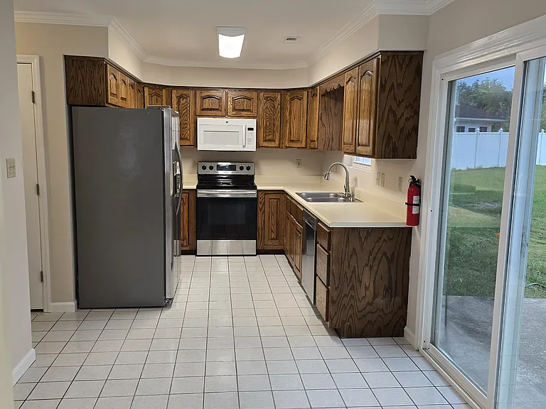 Eat-in kitchen with sliding door to concrete patio. Ceramic tile floor.