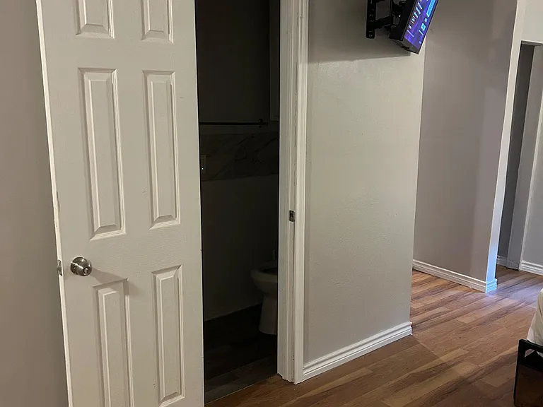 Compact bathroom with toilet and tub/shower combo, conveniently located off the main living area.