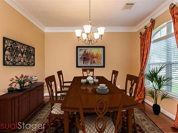 Dining room with wood floors and lots of natural light (virtual staging).