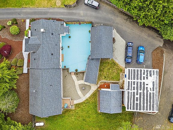 View from the sky of main house and courtyard, 2 garages, well house and a shop. 