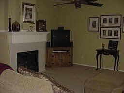 Family room with fireplace is open to kitchen.