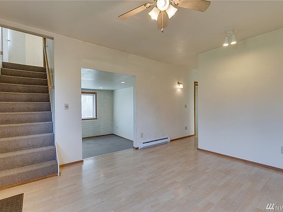 Eating area off of kitchen with openings to stairs and living room.