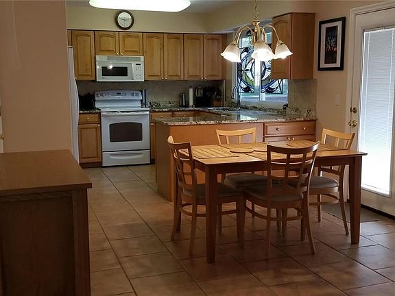 Breakfast room & kitchen with newer tile floors.