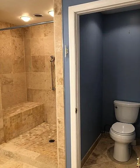 Bathroom with bench and dual shower heads