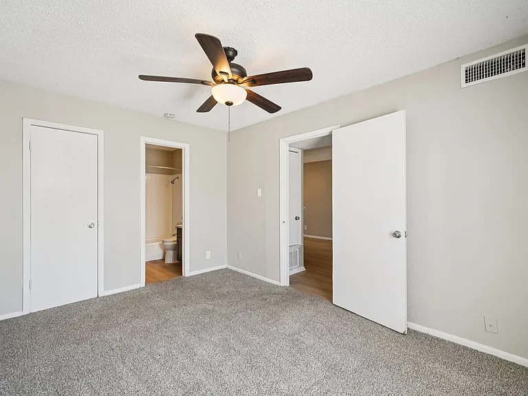 Welcome to The Riley Apartments, where spacious living meets modern comfort. This inviting bedroom features plush carpeting and ample closet space, perfect for your lifestyle. Schedule a tour today and see your new home!