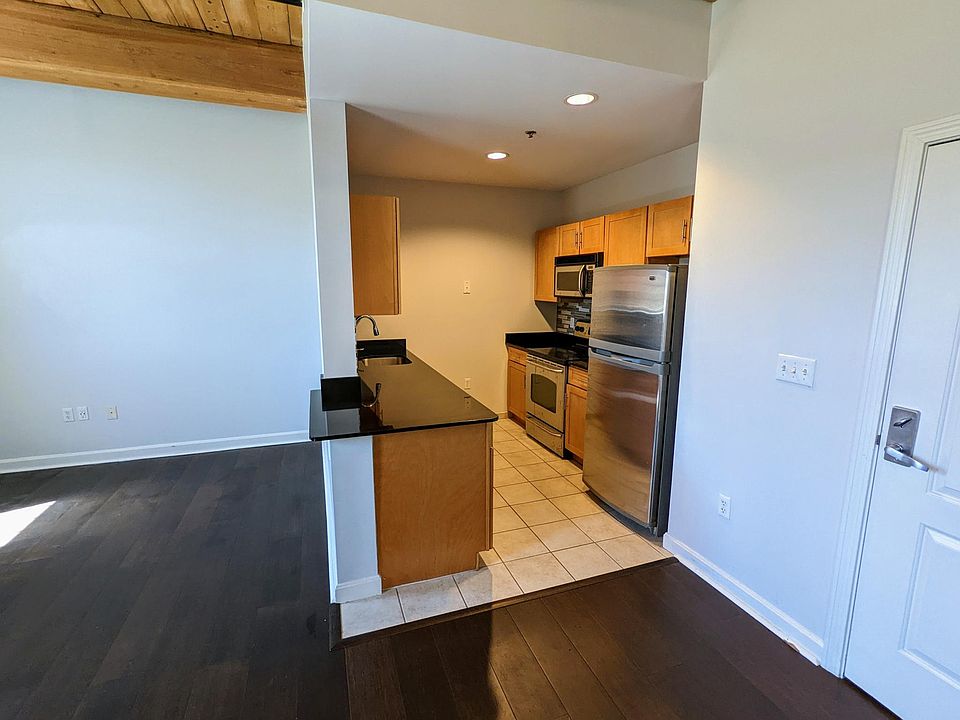 Kitchen icludes refrigerator, dishwasher, stove microwave, storage and work area