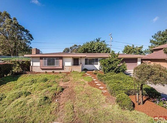 Another view of the front of home. Large picture windows offer abundant light into the living room a
