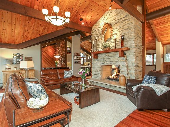 vaulted ceiling and stone fireplace