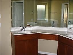 Master bath has a cornered cabinet with dual vanities. 3 sided mirror gives elegance to a new home. 
