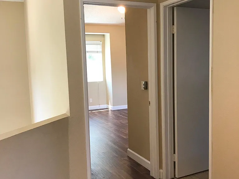 Hallway and full bathroom on the right