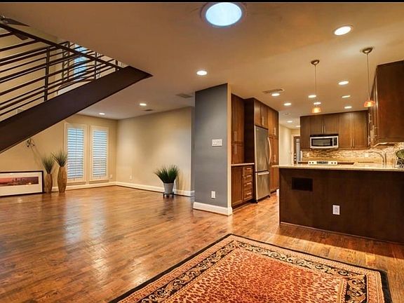 This dining room can also serve as an office if desired. Most recent Tenant used it as Office space. This is the view from the dining room, looking at both the kitchen and the living area and staircase