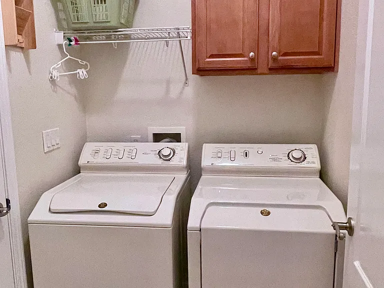 Laundry inside with additional dryer in the garage.