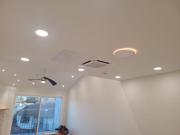 Living room - recessed lights, ceiling fan, central heat, split AC unit
