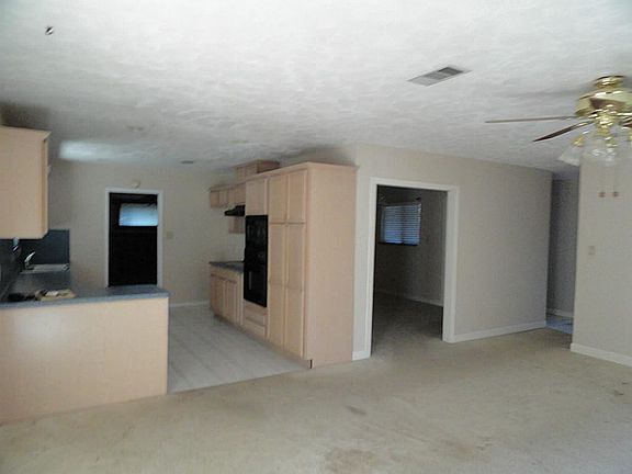 Open floor plan, view from living room into Kitchen and formal dining