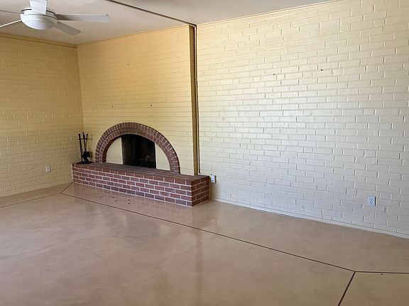 Living room showing ceiling fans and fireplace.