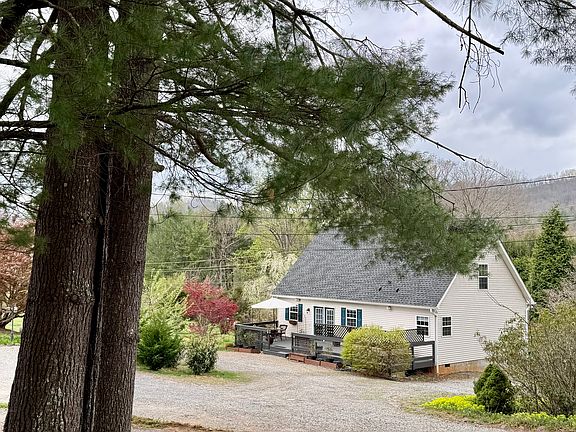 View of the house from the lovely walk out the back door. Notice the privacy and huge driveway!