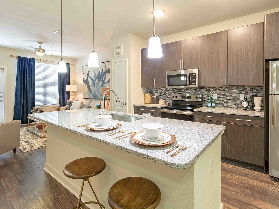 Gourmet kitchens with granite countertops, custom cabinetry with chrome pulls