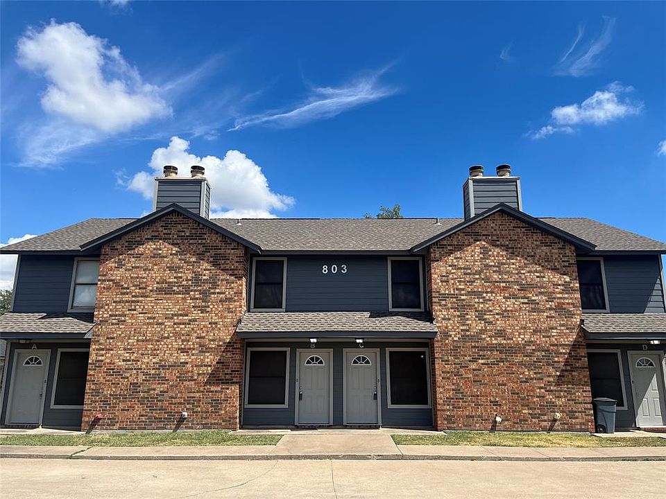 View of front of property with a chimney, brick siding, and a shingled roof