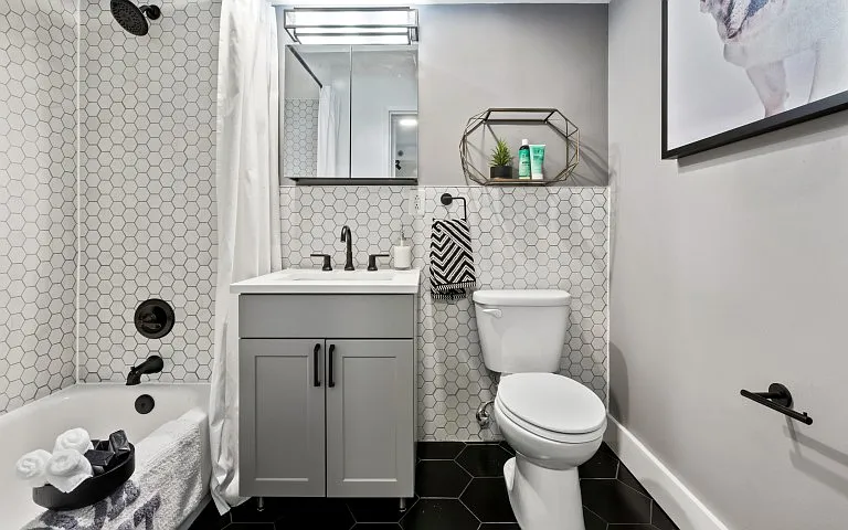 Designer bathroom with elegant all-white bath