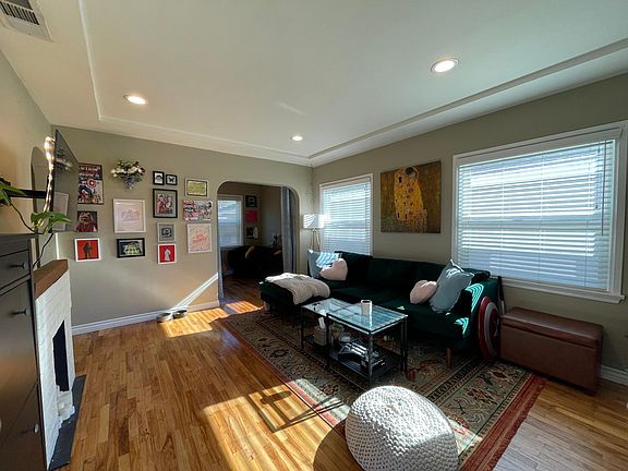 View from the entry door. Living room with recessed lights. Ample window lighting.