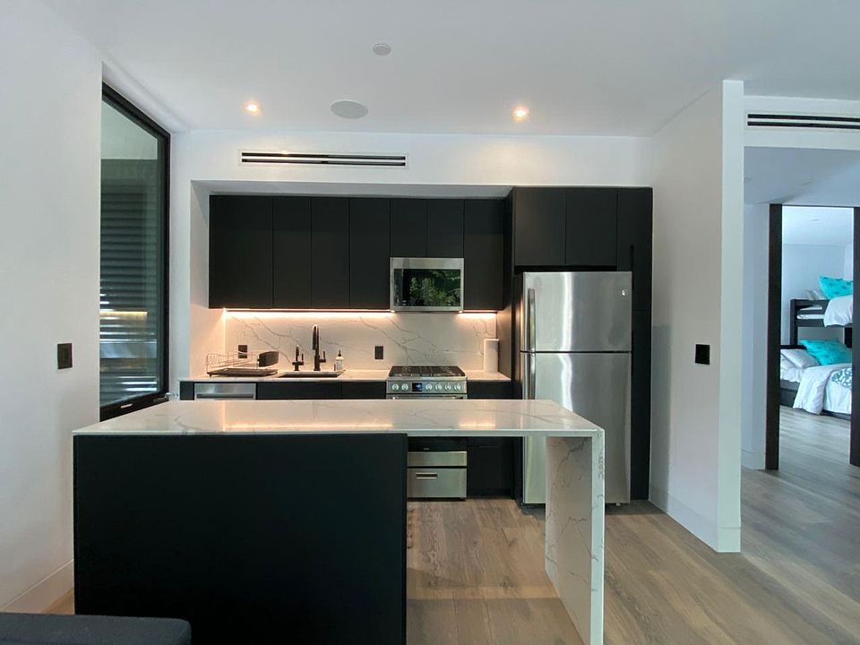 Modern kitchen with gas stove, microwave, fridge and dishwasher. Unit also has a full stackable washer and dryer