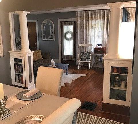 Original columns and cabinets lead to living room