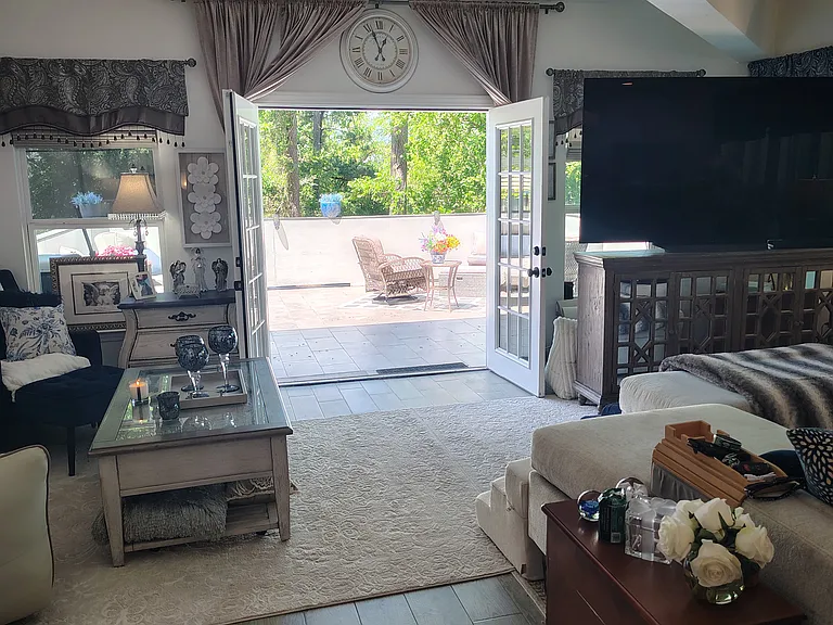 View from living area through French doors out to the large open deck.
