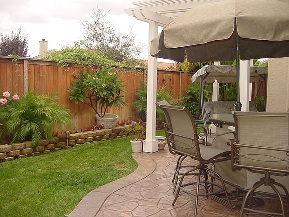 The back yard provides a grassy area as well as plenty of patio space.